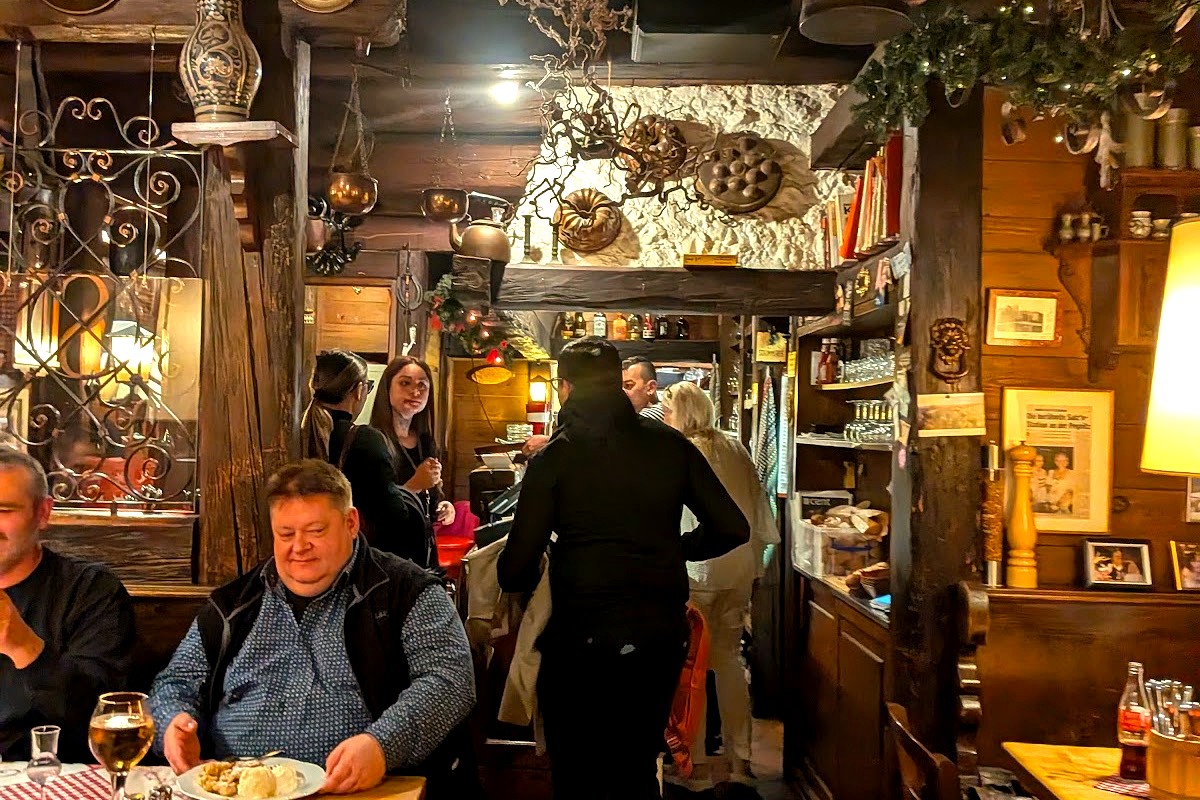 Guests dining in the warm interior of Zum Floessla