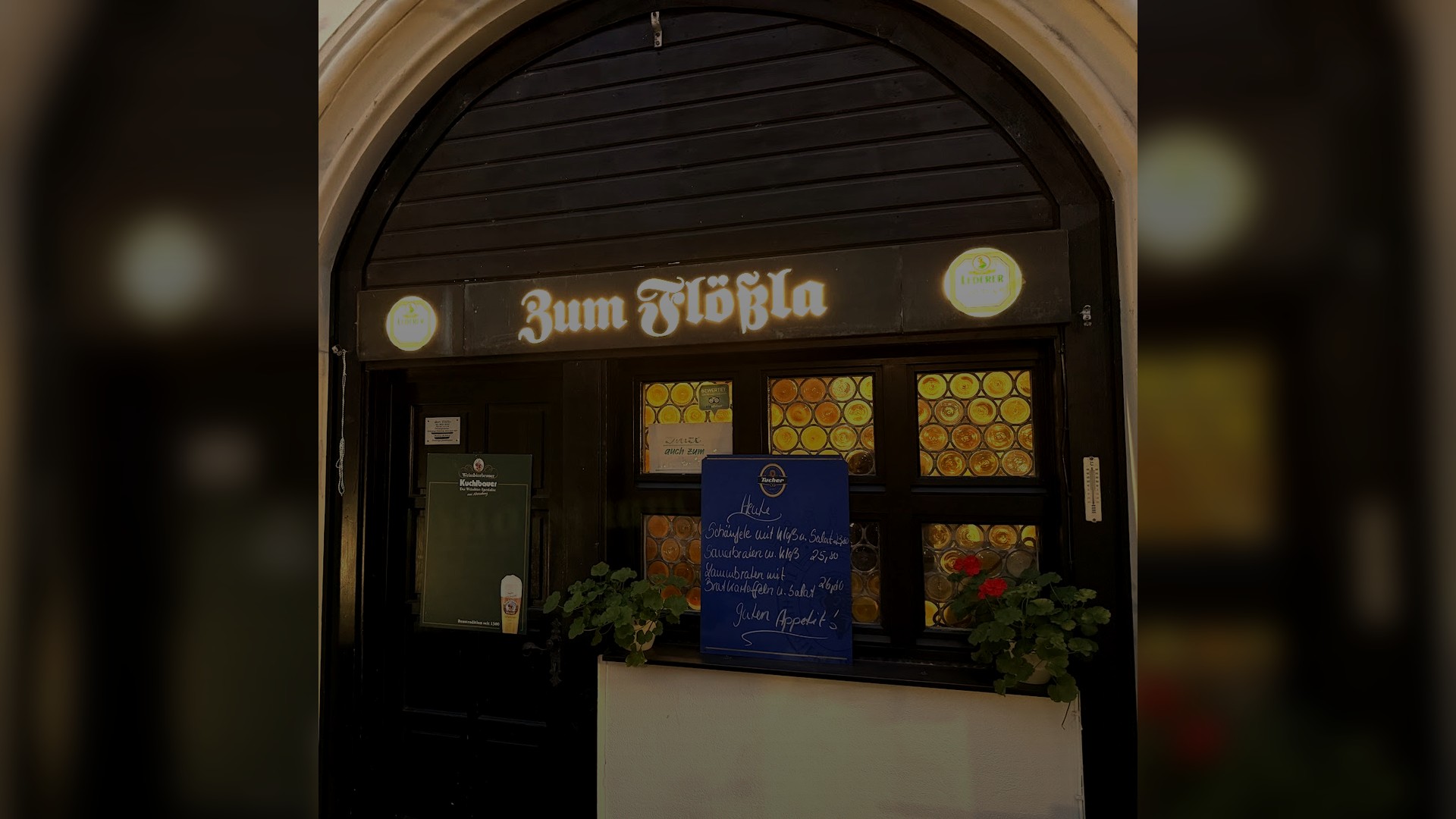 The warmly lit entrance of Zum Floessla in Nuernberg